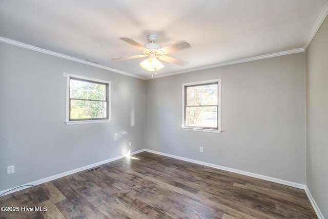 empty room featuring crown molding, a wealth of natural light, and dark hardwood / wood-style floors