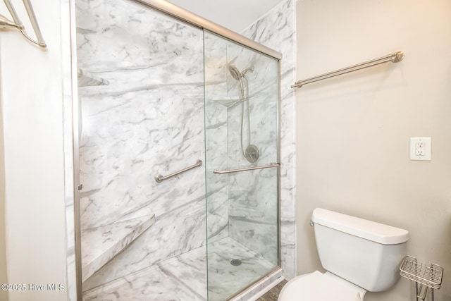 bathroom with an enclosed shower and toilet