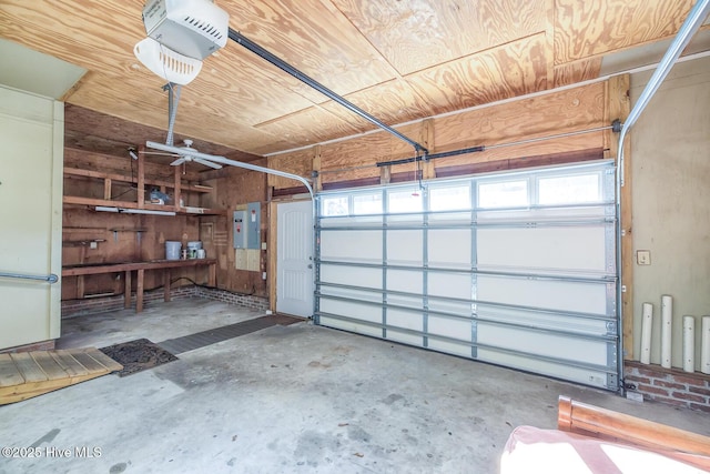 garage with wood ceiling, a garage door opener, and electric panel