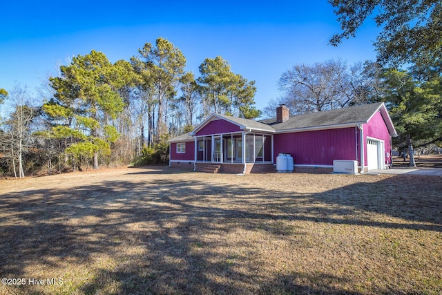 single story home with a front lawn and a sunroom