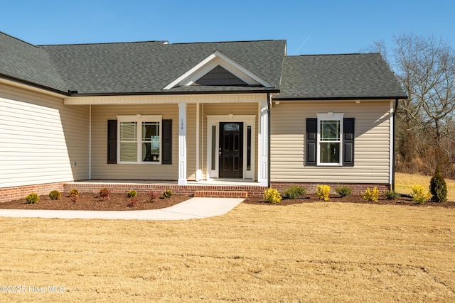 view of front facade featuring a front lawn and covered porch