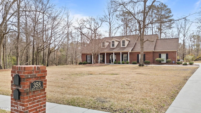 358 Royal Bluff Rd, Jacksonville, NC 28540 - cape cod home featuring brick siding, a front yard, and a shingled roof