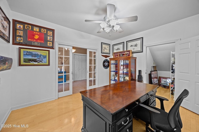 office featuring french doors, baseboards, light wood-style floors, and a ceiling fan