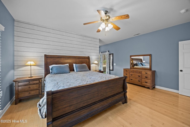 bedroom featuring visible vents, a ceiling fan, light wood-type flooring, and baseboards