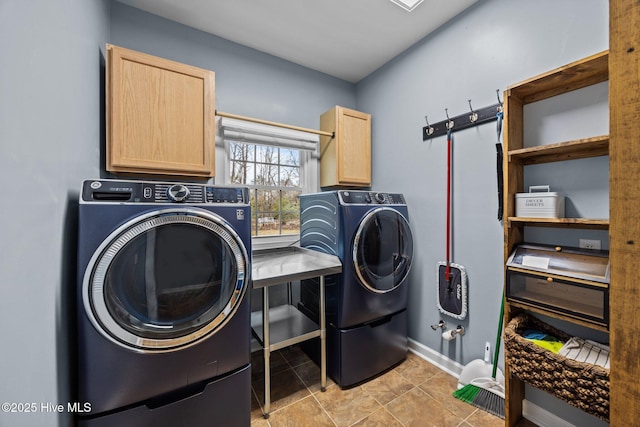 washroom with light tile patterned floors, baseboards, cabinet space, and separate washer and dryer