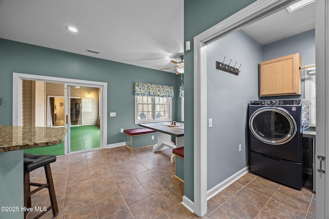 laundry area featuring visible vents, a ceiling fan, washer / clothes dryer, cabinet space, and baseboards