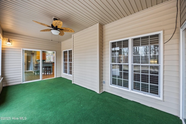 unfurnished sunroom with wooden ceiling and ceiling fan