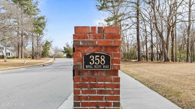 community / neighborhood sign featuring a lawn