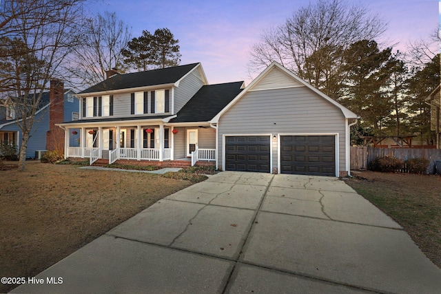 view of front facade with a garage, covered porch, fence, and concrete driveway