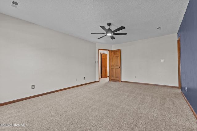 carpeted empty room with a textured ceiling, a ceiling fan, visible vents, and baseboards