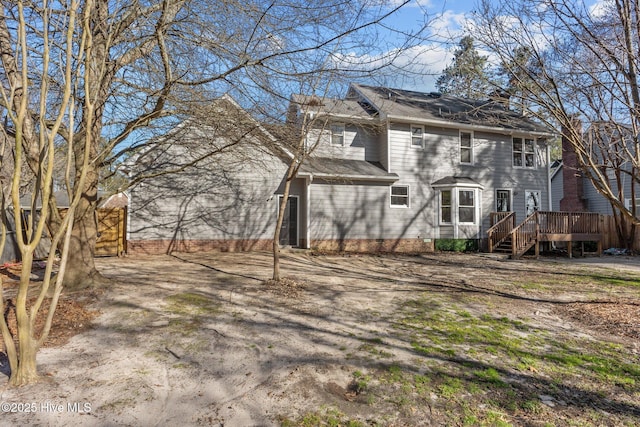 back of property featuring a wooden deck