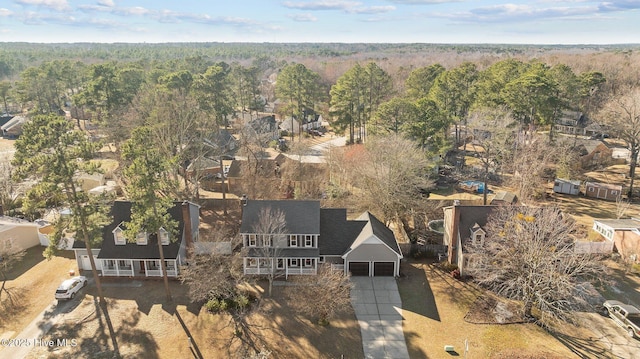 drone / aerial view featuring a view of trees