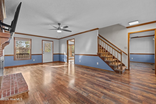 unfurnished living room featuring a ceiling fan, a textured ceiling, stairway, and wood finished floors