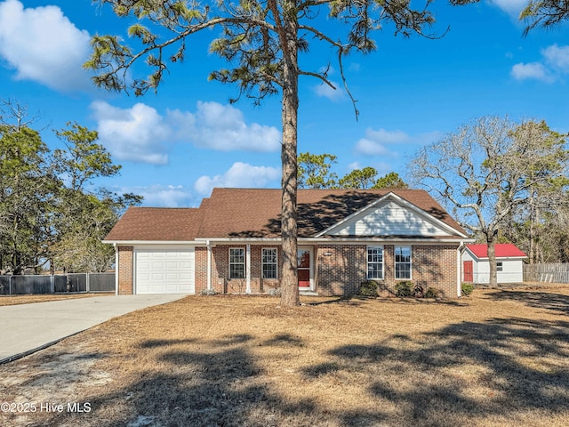 ranch-style home with a garage and a front lawn