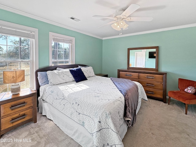 bedroom with light carpet, ornamental molding, and ceiling fan