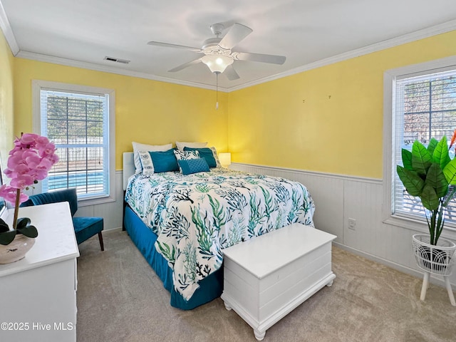 bedroom with crown molding, ceiling fan, and carpet flooring