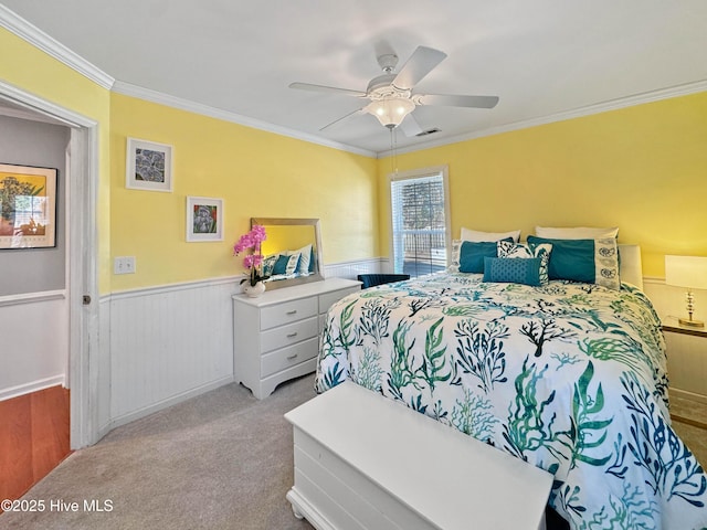 bedroom with crown molding, ceiling fan, and light carpet