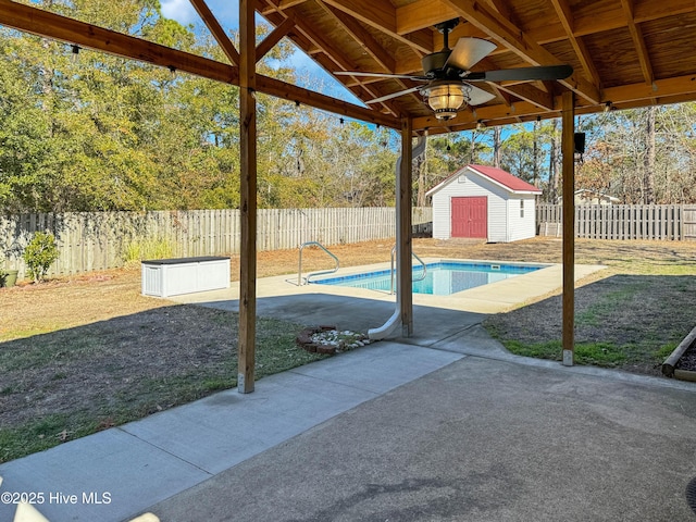 view of patio with ceiling fan, a fenced in pool, and a shed