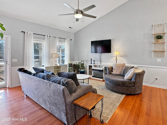 living room with vaulted ceiling, ceiling fan, and hardwood / wood-style floors