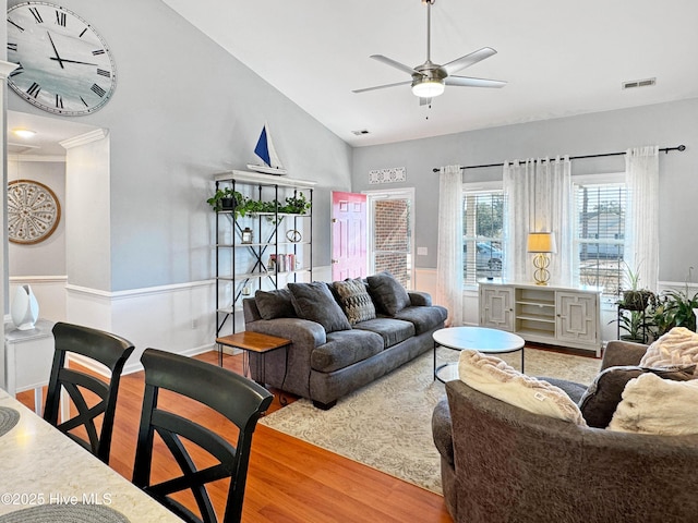 living room featuring lofted ceiling, hardwood / wood-style floors, and ceiling fan