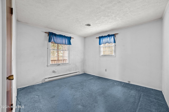 carpeted empty room featuring a textured ceiling and a baseboard heating unit