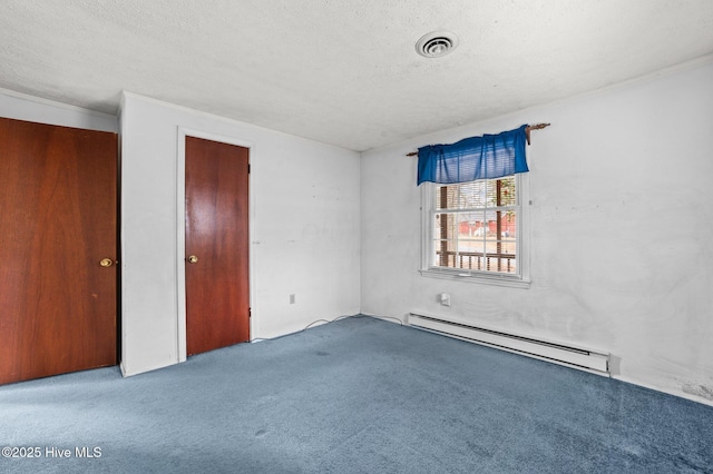 unfurnished room with ornamental molding, light colored carpet, a textured ceiling, and baseboard heating