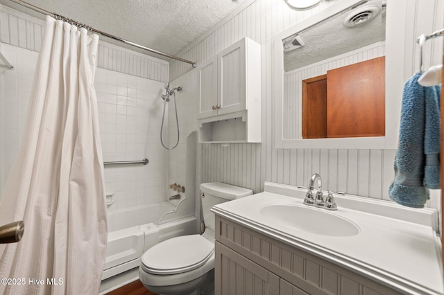 full bathroom with toilet, vanity, a textured ceiling, and shower / bath combo with shower curtain