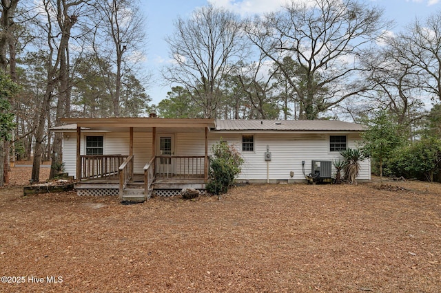 rear view of property featuring central AC