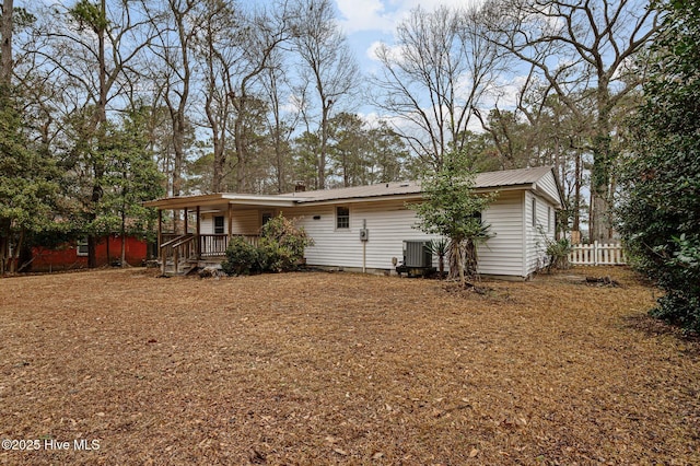 back of house with central AC