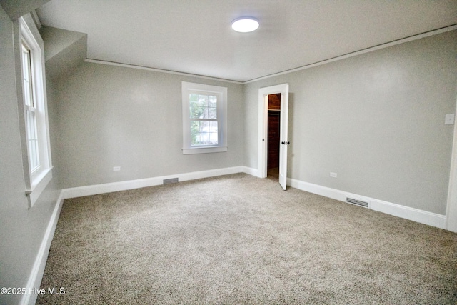 carpeted spare room with crown molding