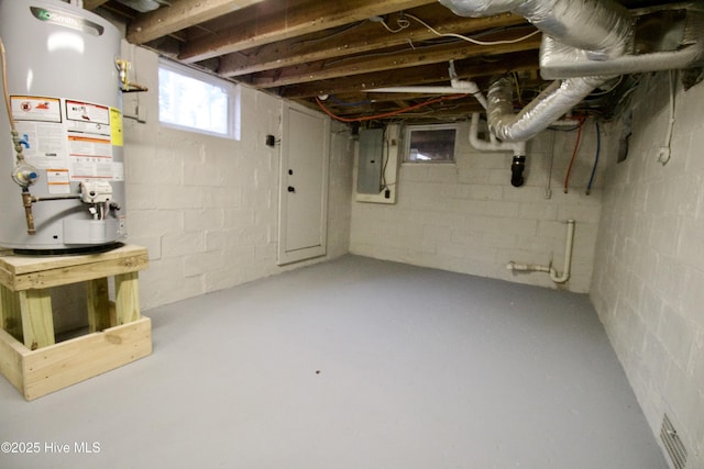 basement featuring water heater and electric panel