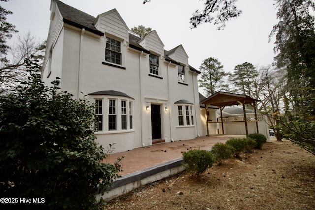 back of property with a gazebo and a patio