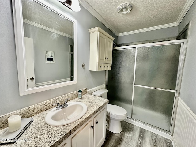 bathroom with an enclosed shower, crown molding, wood-type flooring, and a textured ceiling