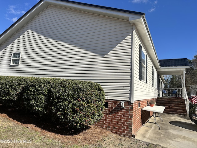 view of side of property featuring a patio area