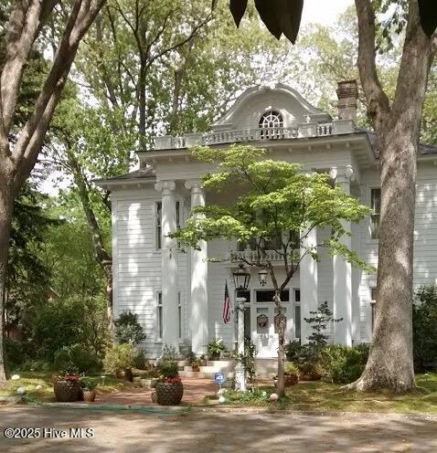 view of front of property featuring a chimney