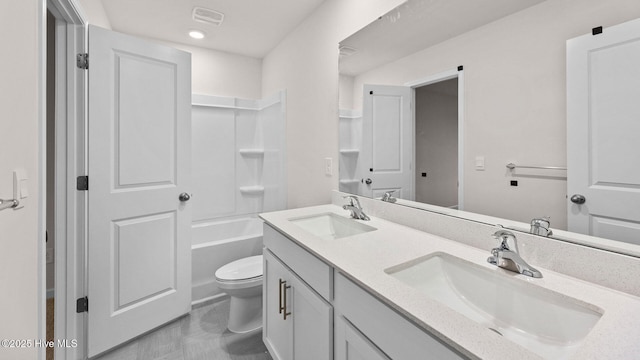 full bathroom featuring washtub / shower combination, vanity, and toilet