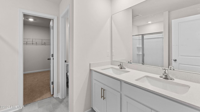 bathroom with vanity and a shower with shower door