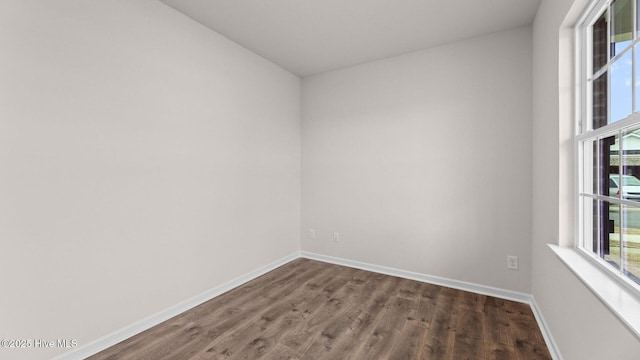 empty room featuring dark wood-type flooring