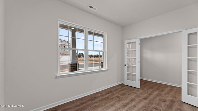 unfurnished bedroom with wood-type flooring and french doors