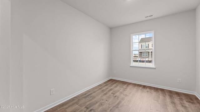 spare room featuring wood-type flooring