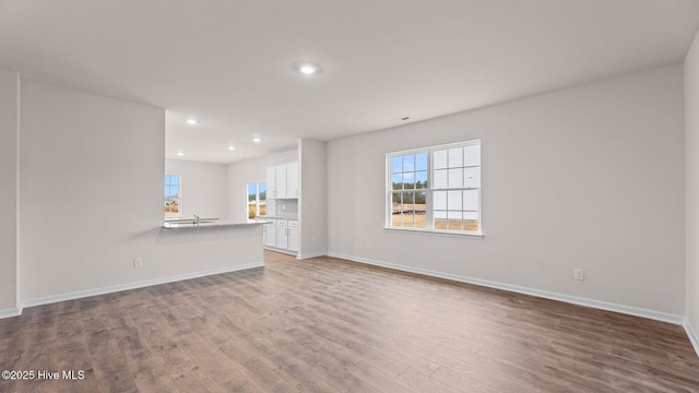 unfurnished living room featuring hardwood / wood-style flooring