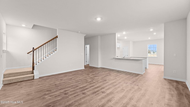 unfurnished living room featuring light wood-type flooring