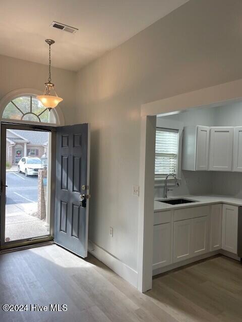 entrance foyer featuring sink and light wood-type flooring