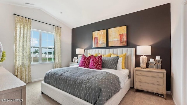 bedroom featuring lofted ceiling and light colored carpet