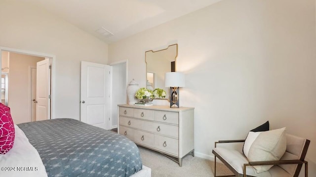 bedroom featuring lofted ceiling and light carpet