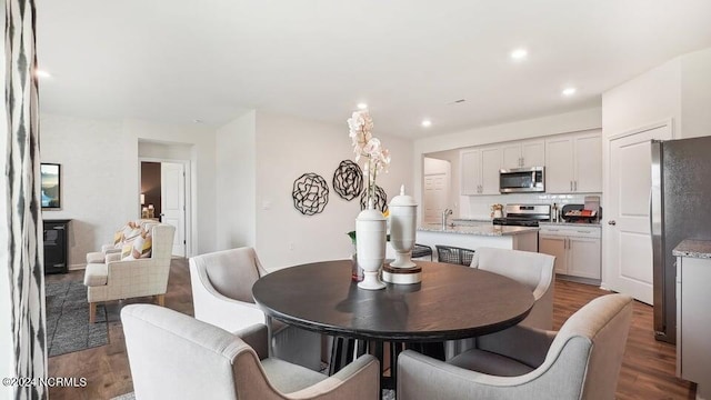 dining room with sink and hardwood / wood-style floors