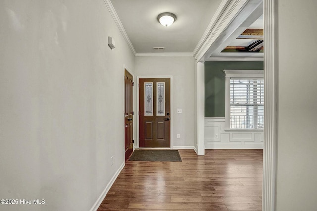 foyer entrance featuring dark wood-type flooring and ornamental molding