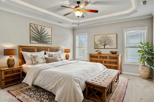 carpeted bedroom with crown molding, ceiling fan, and a tray ceiling