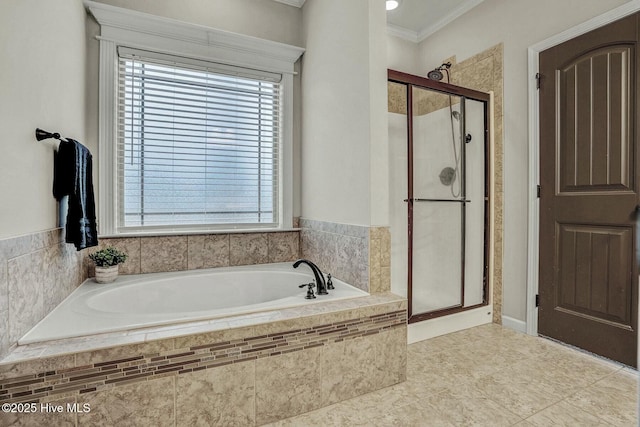 bathroom featuring ornamental molding and shower with separate bathtub