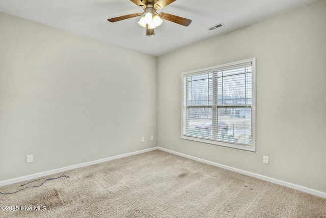 carpeted empty room featuring ceiling fan